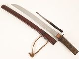 a close up of a knife with a wooden handle on a white surface