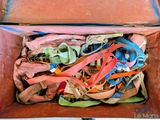 a brown box filled with lots of different colored ties