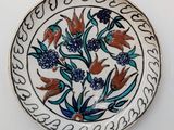 a plate with flowers on it sitting on a table
