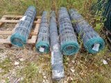 many rolls of wire on the ground next to a pallet