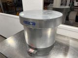 a metal container sitting on top of a metal table