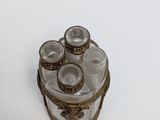 a small glass box with four glasses on it