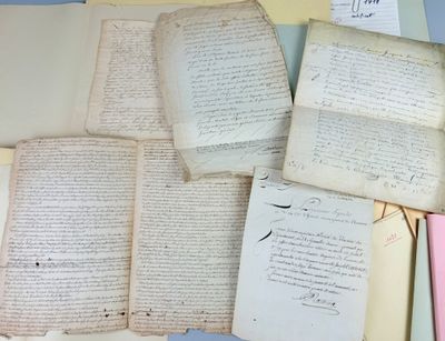 several old papers are stacked on top of each other on a table