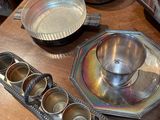 a wooden table topped with bowls and pans on top of it