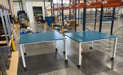 deux tables posées au milieu d'un entrepôt