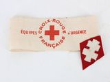 an old red cross patch on a white cloth with a red cross on it