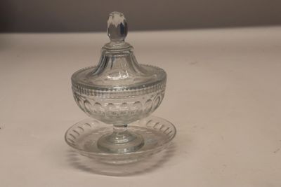 a small glass bowl with a lid on a table
