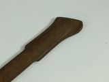 a wooden stick that is laying on a white surface