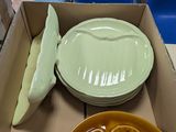 a box full of plates and bowls on a table