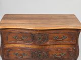 an old wooden chest of drawers with ornate carvings on the drawers