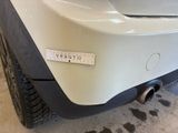 a sticker on the bumper of a white car