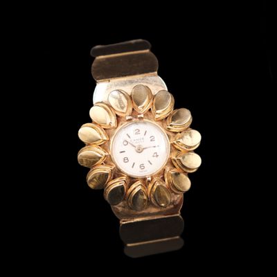 a gold watch with a white face on a black background