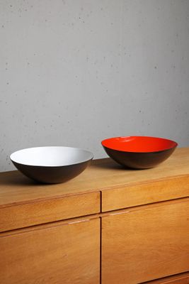 two bowls sitting on top of a dresser next to each other