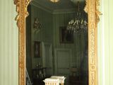 a fireplace with a mantle and a mirror on it