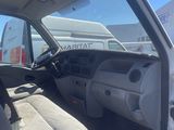 the interior of a white van with the driver ' s seat up