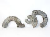 two pieces of stone sitting next to each other on a white surface