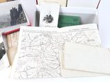 a lot of old maps and postcards in a box