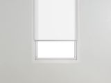 an empty room with white walls and a window in the corner