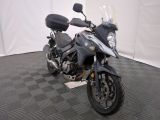 a motorcycle that is parked on a checkered floor