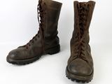 a pair of brown boots with laces on them on a white background