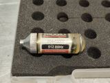a small bottle of liquid sitting on top of a piece of plastic