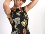 a woman that is posing for a picture in a dress