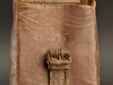 a small piece of pottery with a handle on it