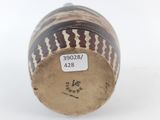 a close up of a vase with a tag on it