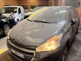 the grey car is parked in the garage next to other cars