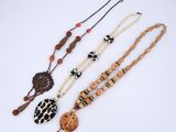 a group of three necklaces on a white surface