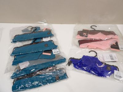 four pairs of blue and pink shoes on a white table