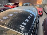 many old cars parked in a parking lot next to each other