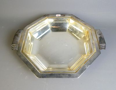 a silver plate on a table with a white background