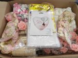 a box with a bunch of pink and white flowers inside of it