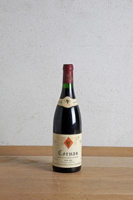 a bottle of wine sitting on top of a wooden table