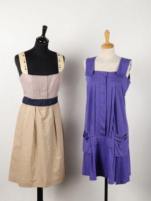 two dresses on a mannequin stand next to a dress on a mannequin stand