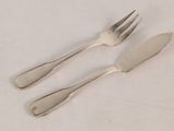 two forks and a knife on a white table
