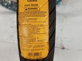 an image of a close up of a tire with a yellow label on it