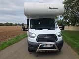 a white van that is parked on the side of the road