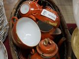 a basket full of plates and bowls on a table