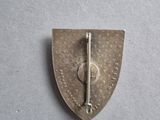 an image of a small metal pin with a cross on it