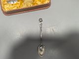 a spoon that is sitting on a table next to a box