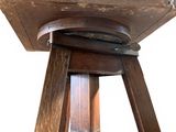 a small wooden table with a wooden top and a metal base