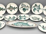 beaucoup d'assiettes avec du poisson dessus sur une table