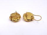 a pair of gold earrings on a white background