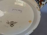 a white and blue bowl and a white and blue vase