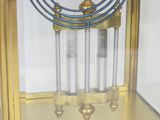 a gold clock with a glass case on it