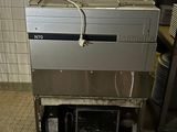 a machine that is sitting on a cart in a kitchen