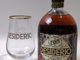 a bottle and a glass sitting next to each other on a table