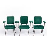 a set of four green velvet chairs with metal legs